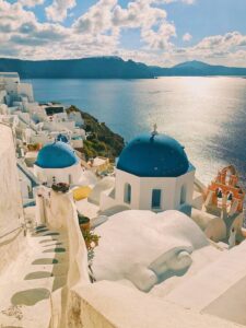 A photo of Santorini from above with the village and the coast in the frame during a women's only group tour of Greece