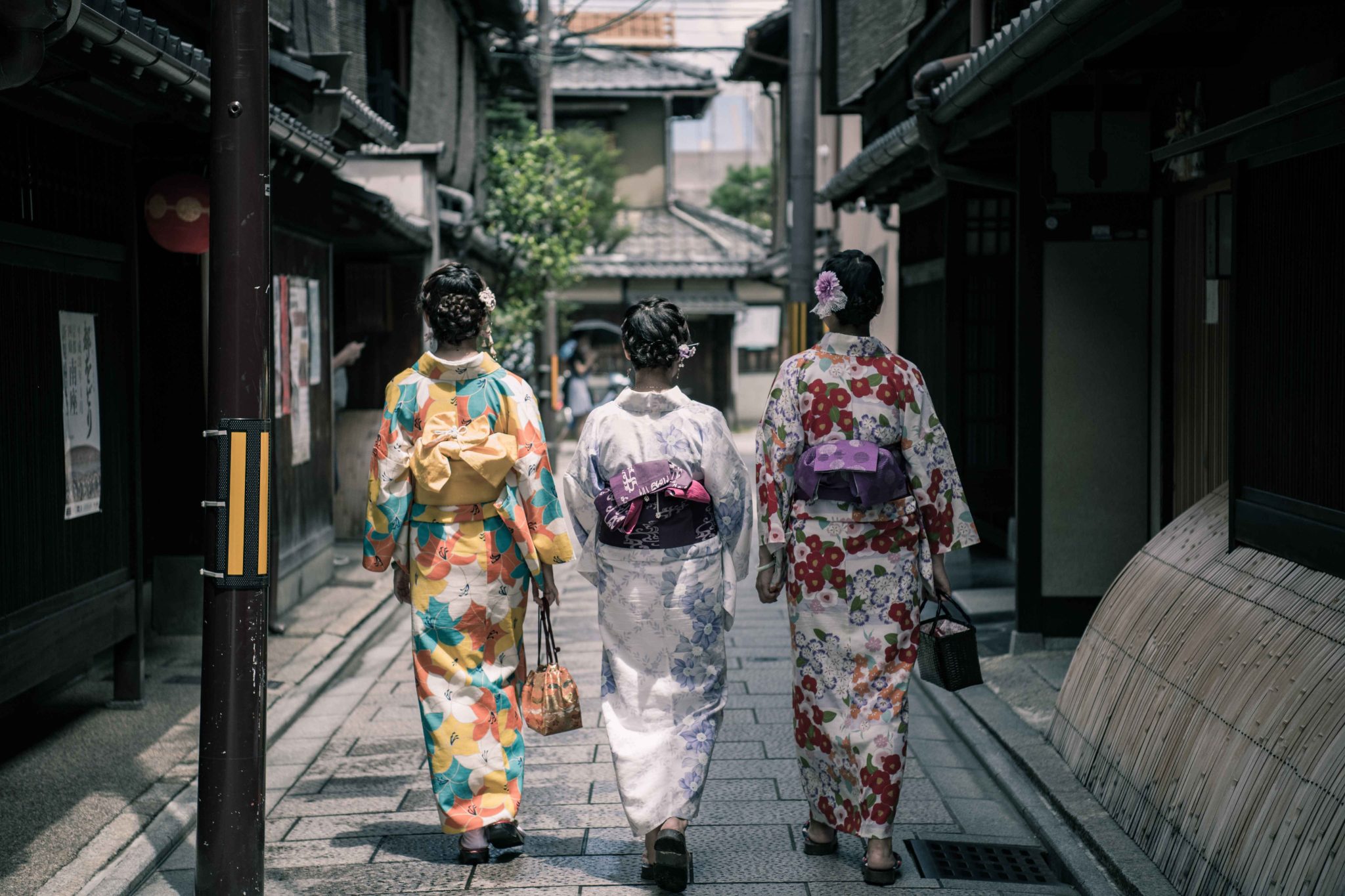 Geishas in Japan walking down a street