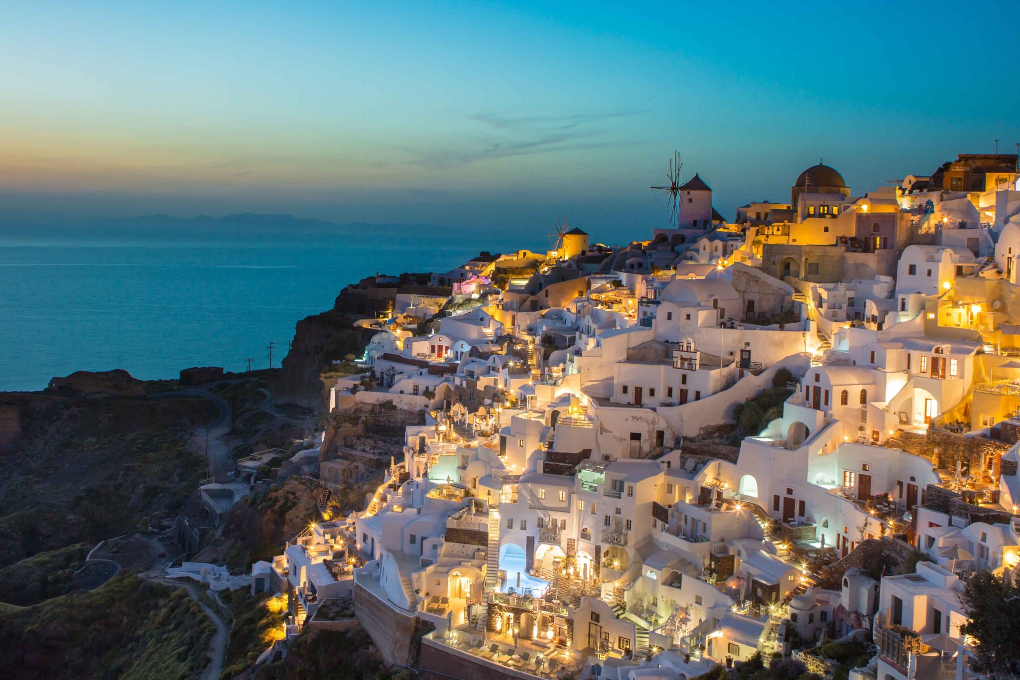An aerial view of a greek coastal village at dusk while on a women's only tour of Greece