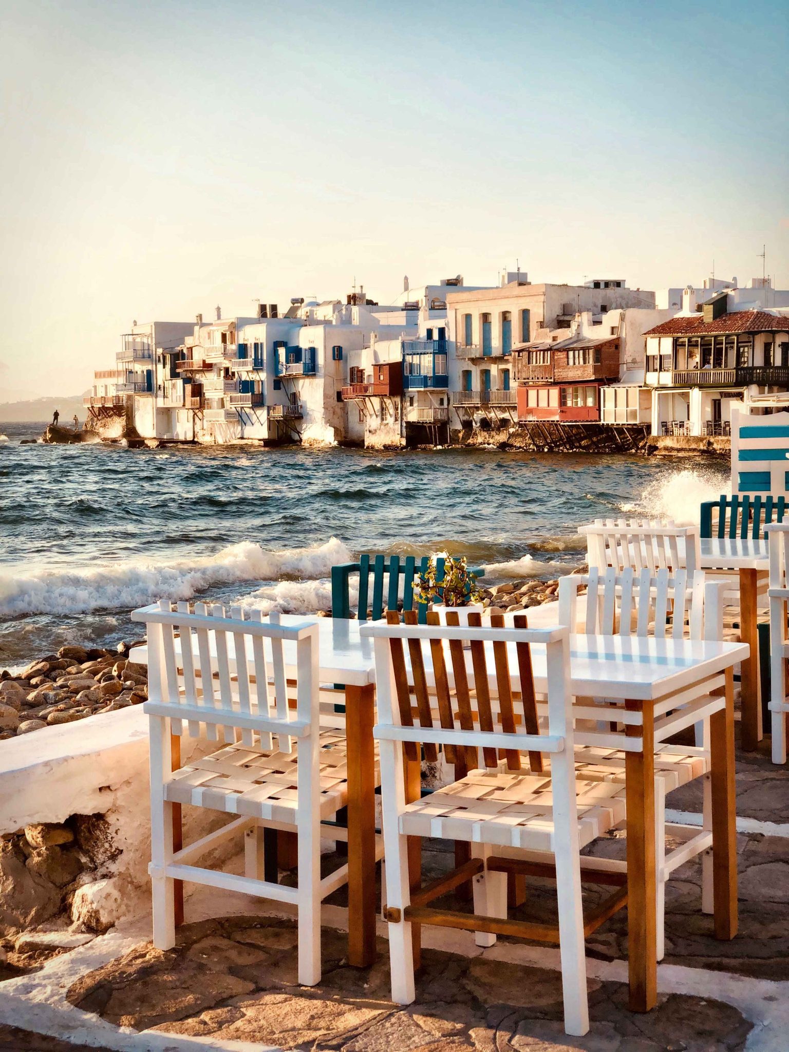 A photo of a coast side restaurant in a town in Greece