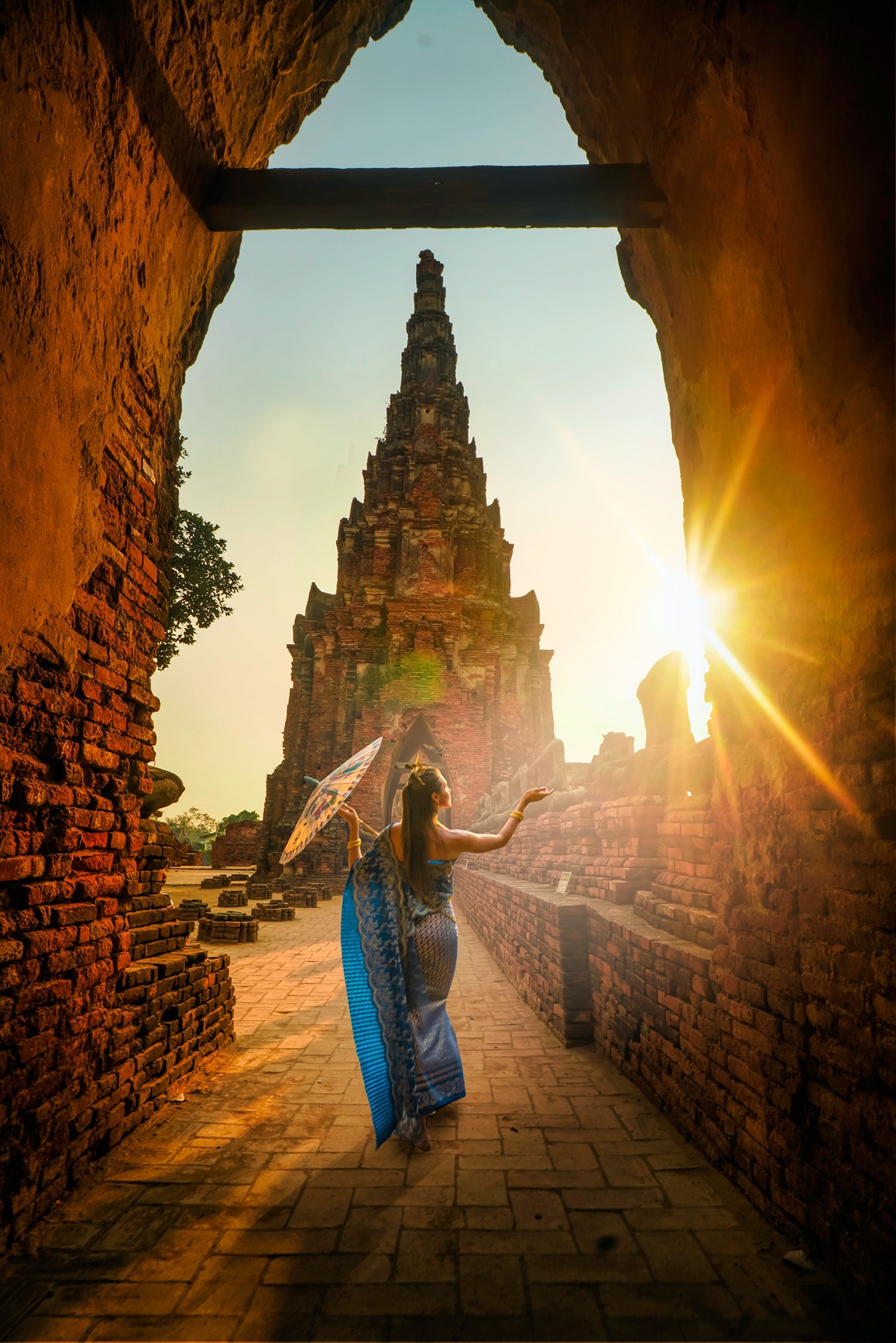 A woman in the sunshine outside a Thai temple
