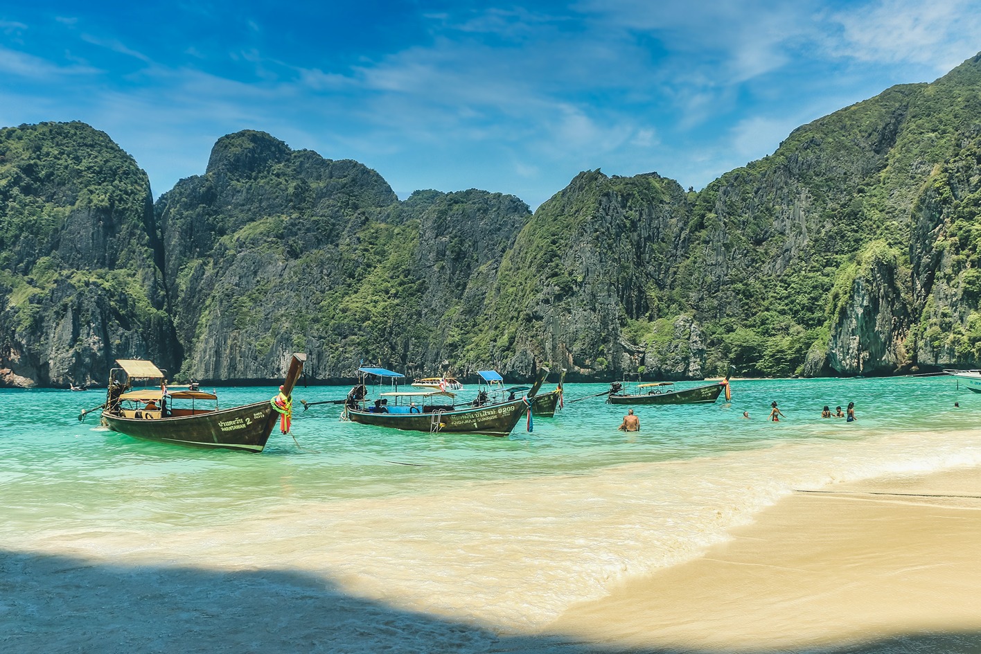 Thai wooden boats along the shore in Coastal Thailand