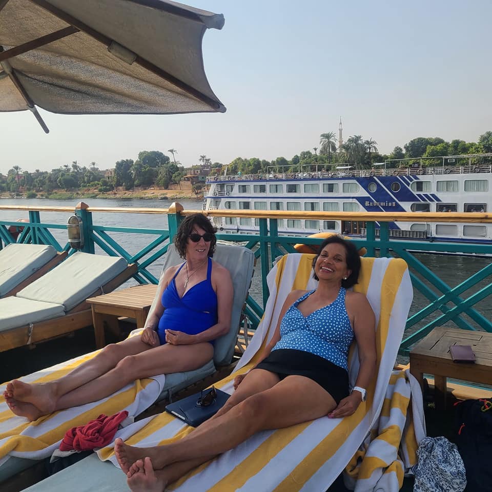 Two female travellers relaxing in lounge chairs on a Nile River Cruise during Womens Travel Network's tour in Egypt